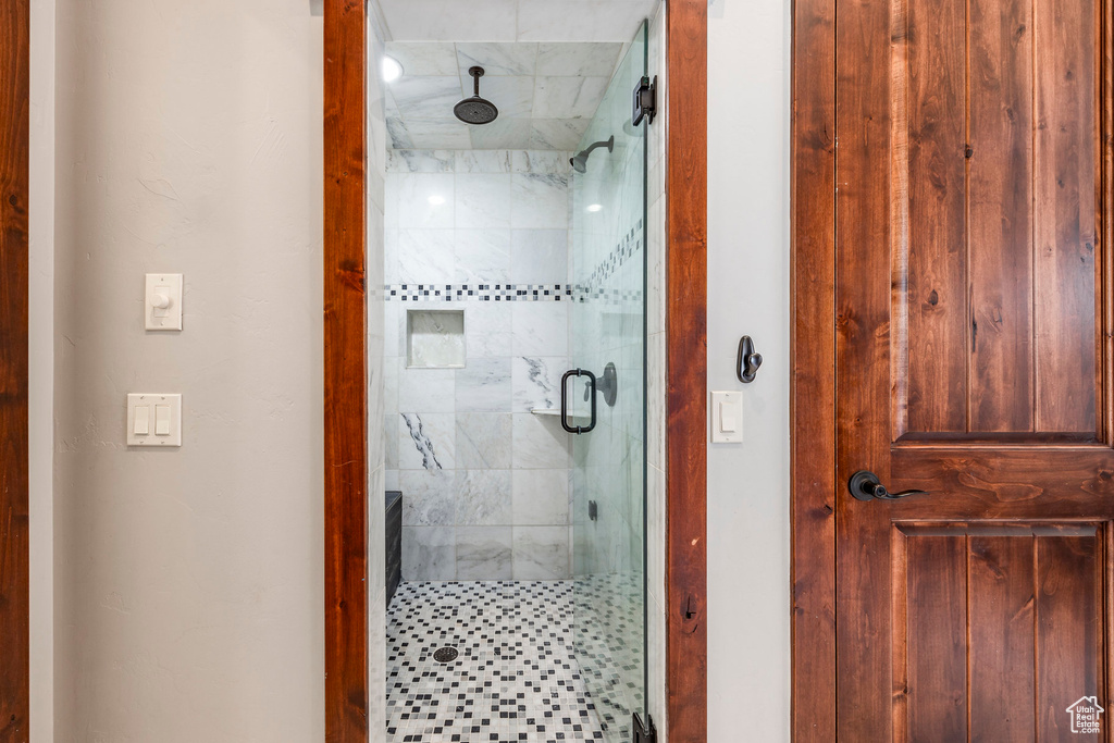 Full bathroom featuring a shower stall