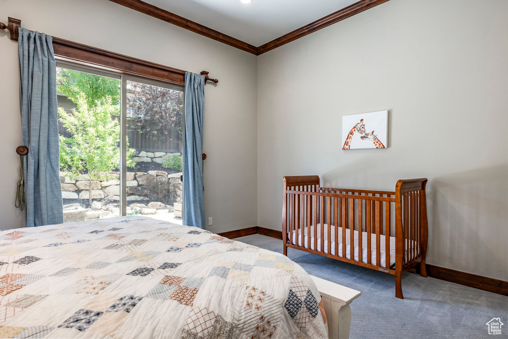 Carpeted bedroom with crown molding and baseboards
