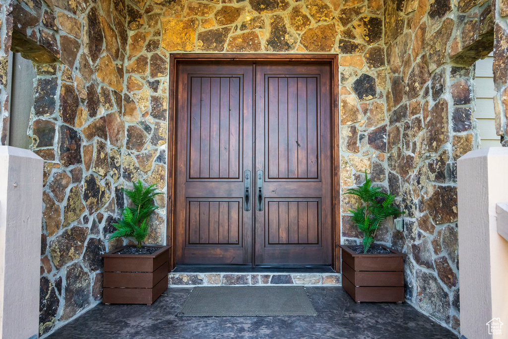 Doorway to property featuring stone siding
