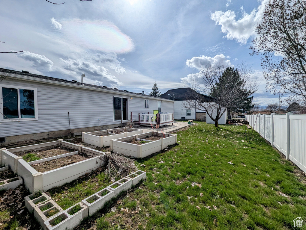 View of yard with a garden and fence