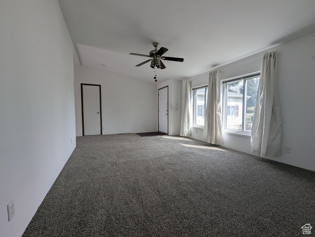 Carpeted spare room with ceiling fan