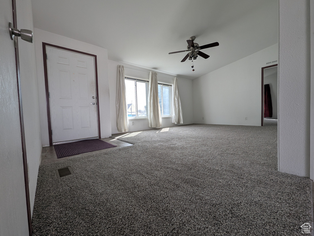 Interior space featuring ceiling fan, visible vents, and carpet floors