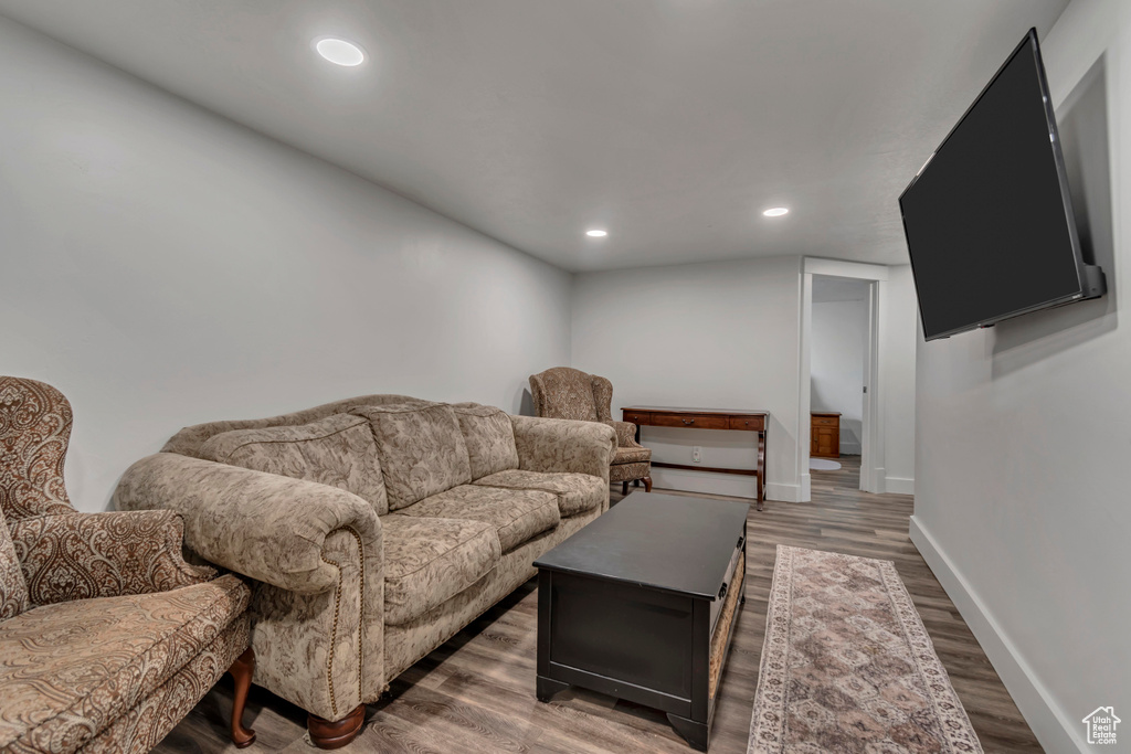 Living area featuring wood finished floors, baseboards, and recessed lighting