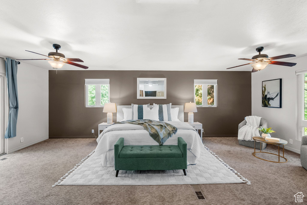 Carpeted bedroom featuring ceiling fan