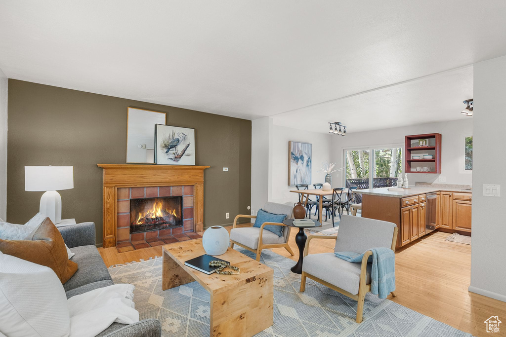Living area with light wood-style floors and a fireplace
