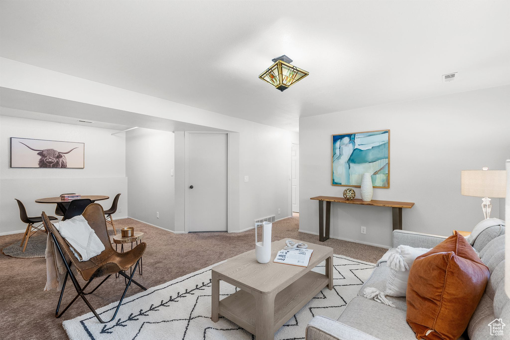 Living room featuring carpet and baseboards