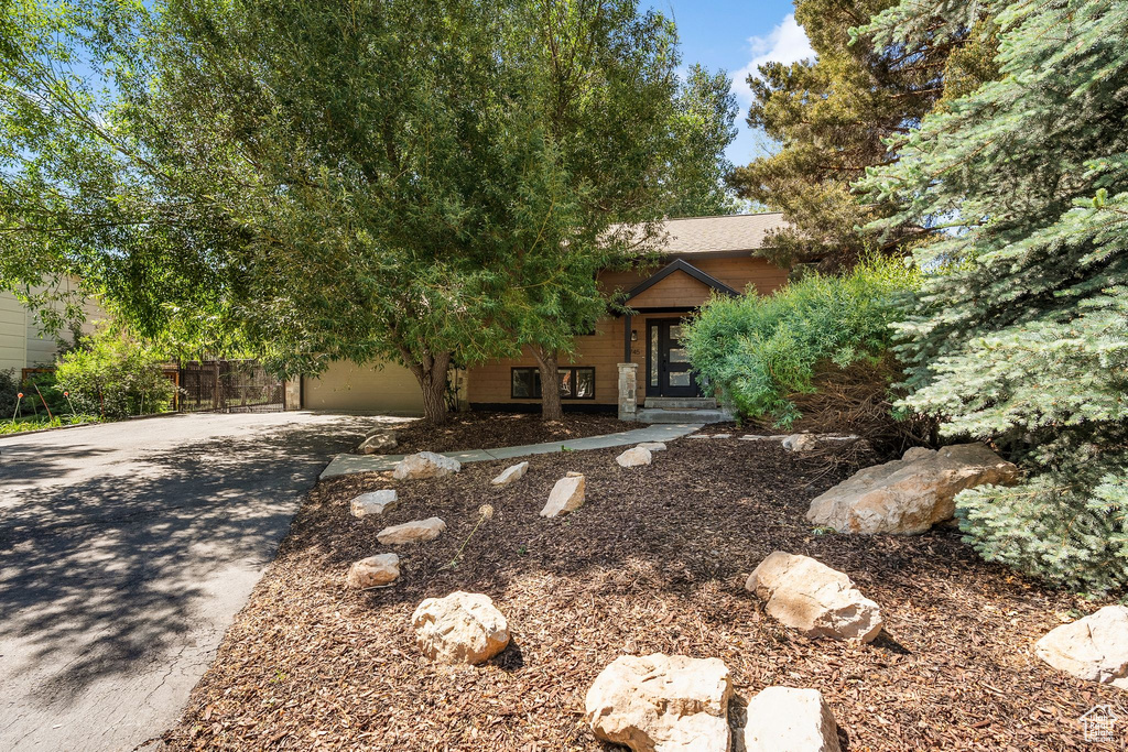 Obstructed view of property featuring concrete driveway