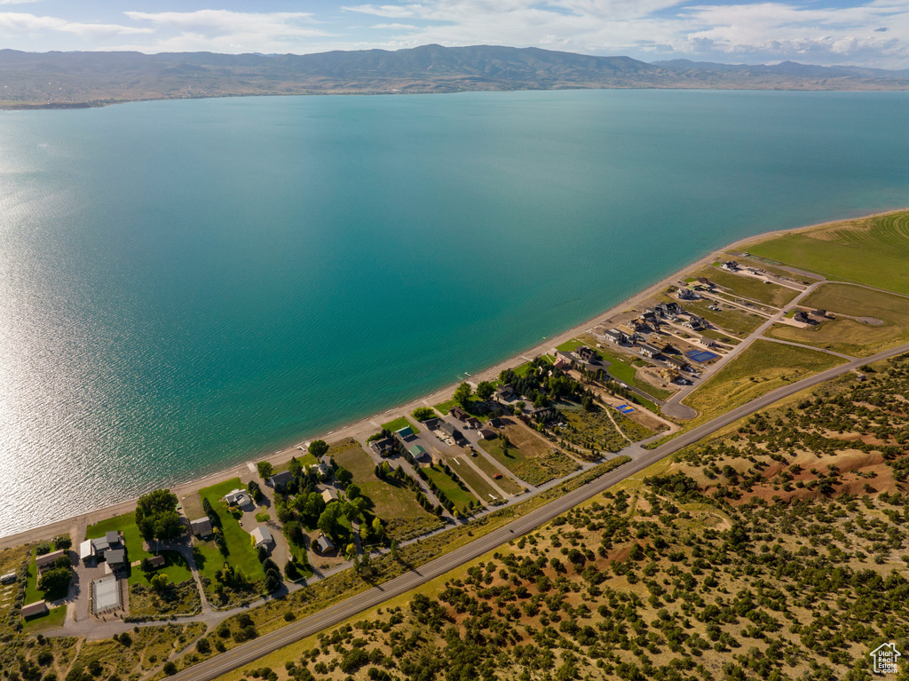 Drone / aerial view featuring a water and mountain view