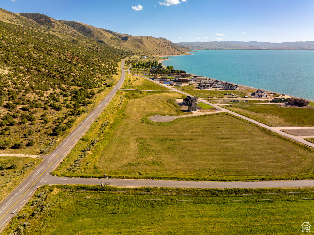 Birds eye view of property with a water and mountain view