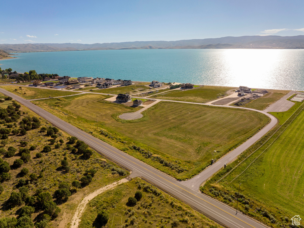 Birds eye view of property featuring a water and mountain view
