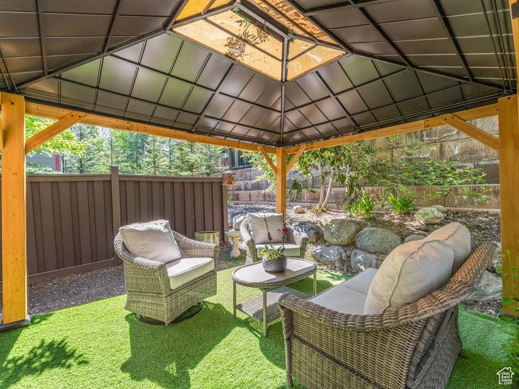 Fenced backyard featuring a gazebo