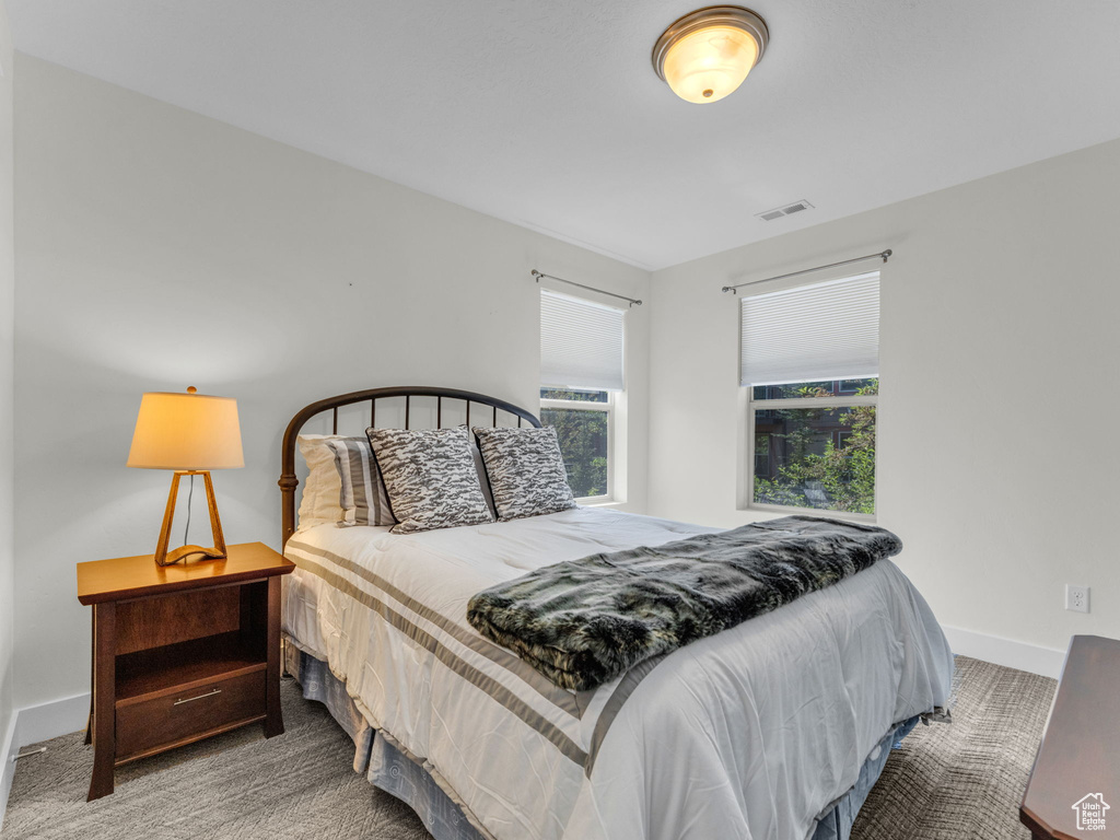 Carpeted bedroom featuring baseboards