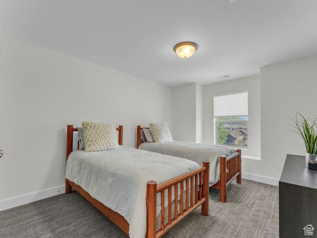 Carpeted bedroom with baseboards