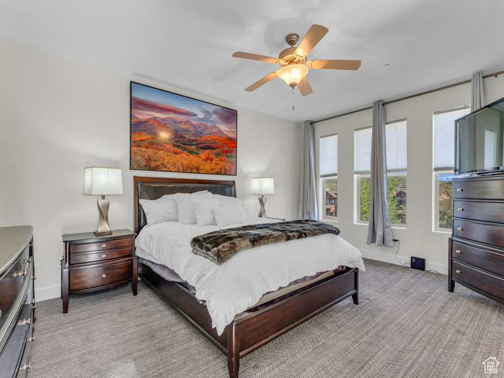 Bedroom with baseboards, carpet floors, and ceiling fan