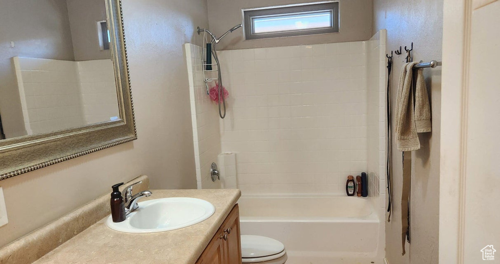 Bathroom with vanity and shower / washtub combination