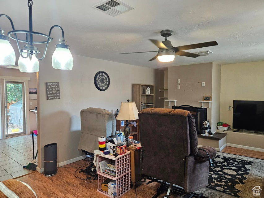 Living room with ceiling fan and wood finished floors