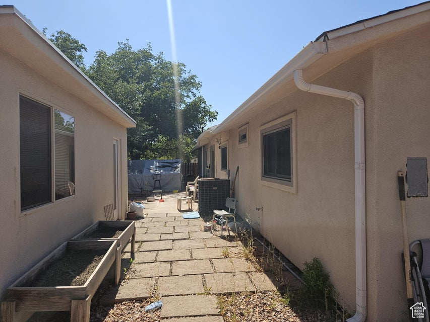View of home's exterior with stucco siding and a patio