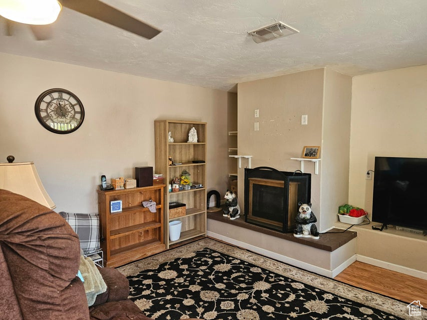 Living area with a fireplace and wood finished floors
