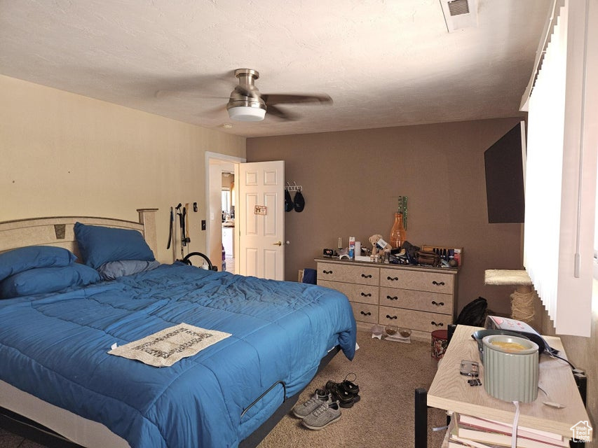 Bedroom featuring carpet and a ceiling fan