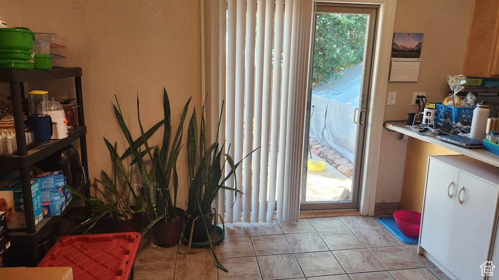 Entryway with light tile patterned floors
