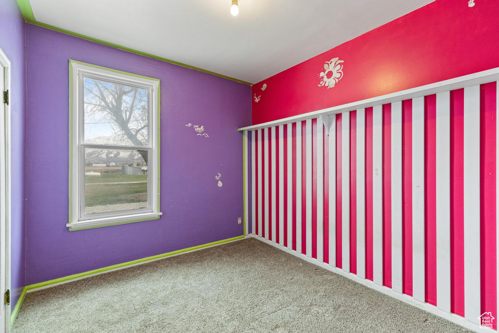 Empty room with baseboards and carpet flooring