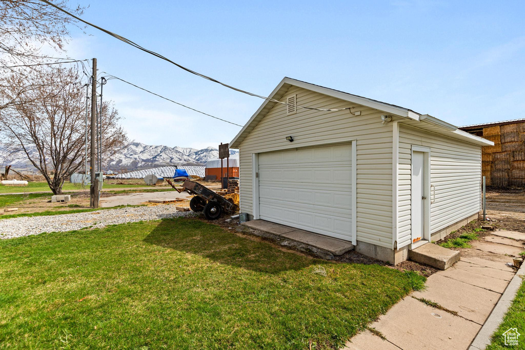Garage with a mountain view and fence