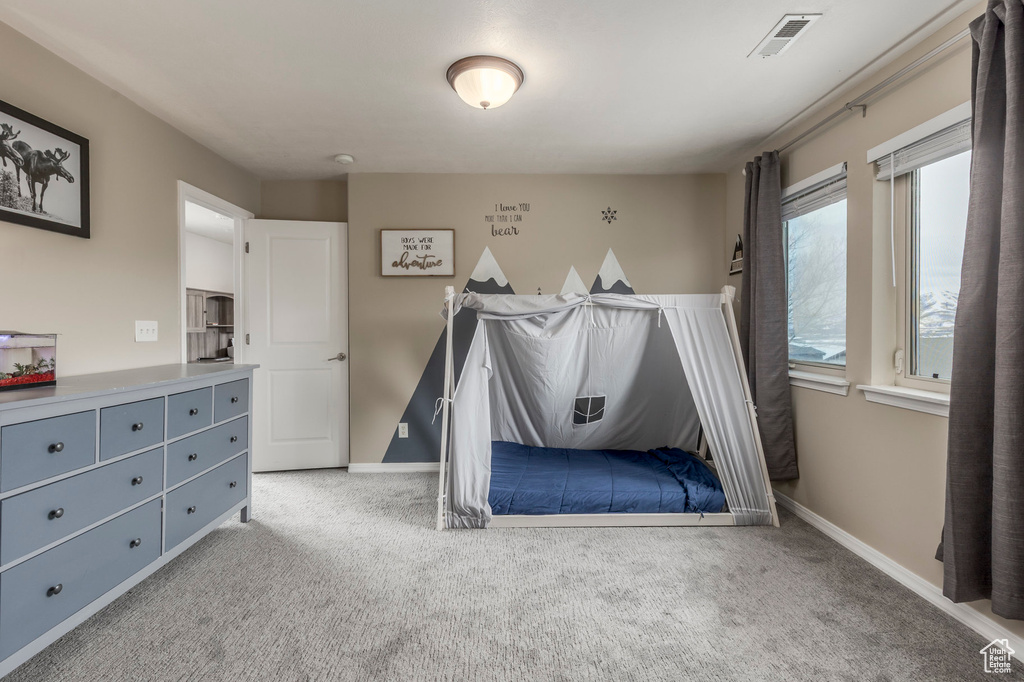 Carpeted bedroom featuring baseboards