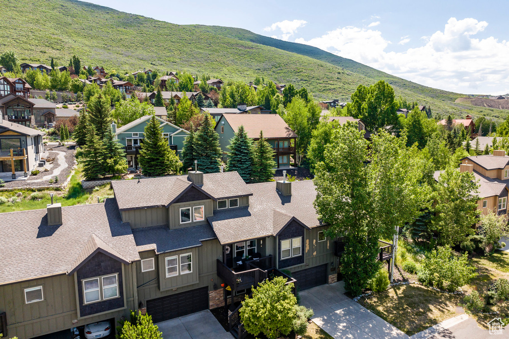 Aerial perspective of suburban area featuring a mountainous background
