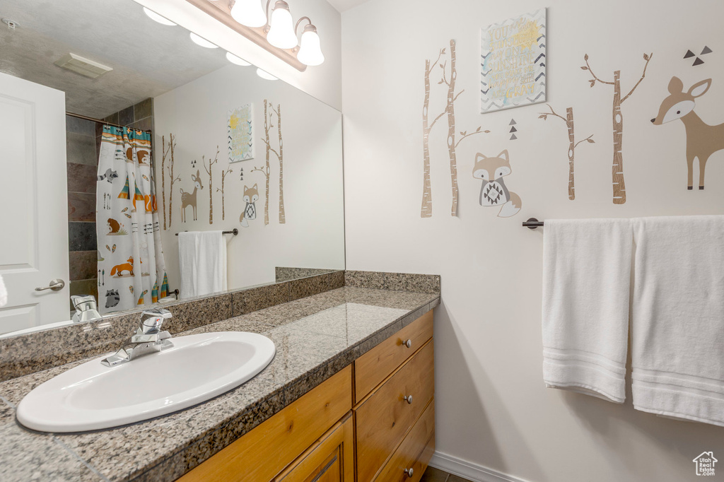 Bathroom with vanity and a shower with curtain