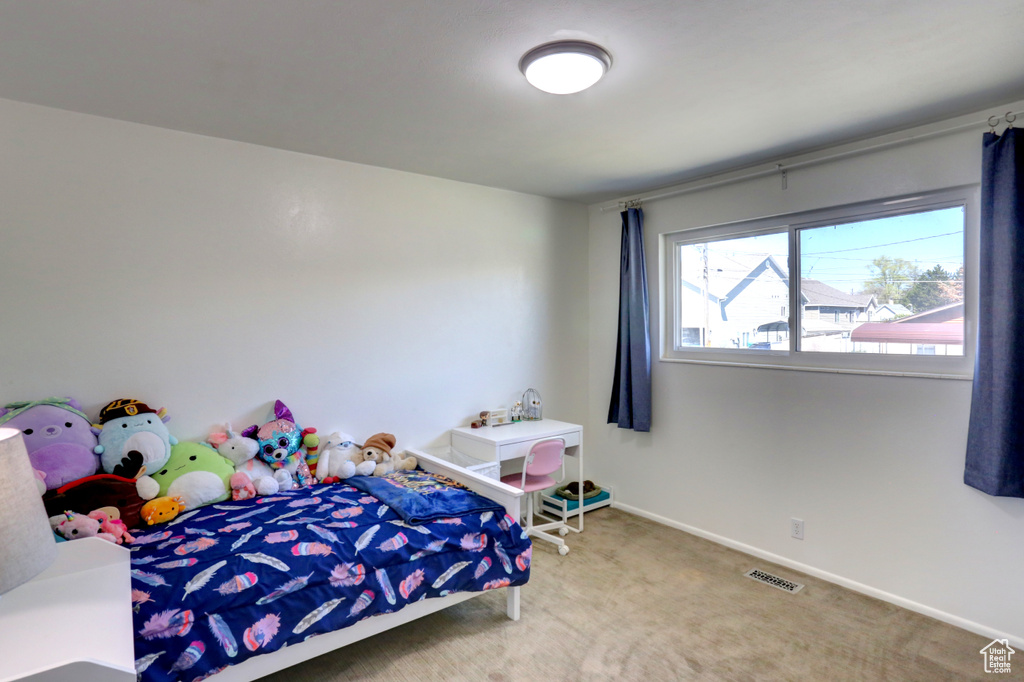 Bedroom featuring baseboards, visible vents, and carpet