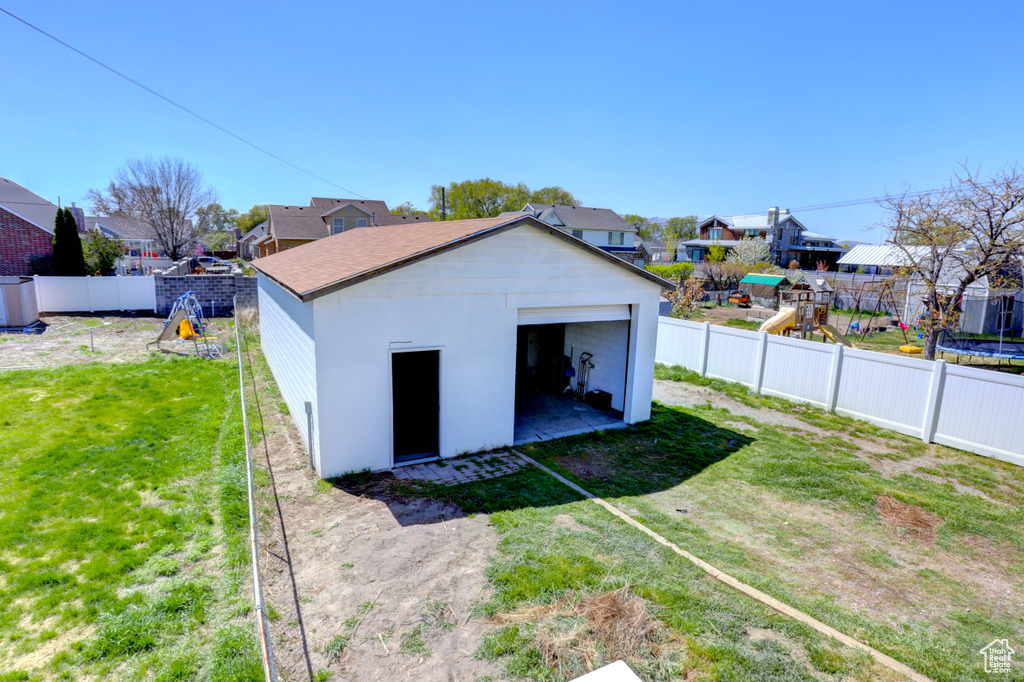 Exterior space with a fenced backyard, a residential view, and a playground