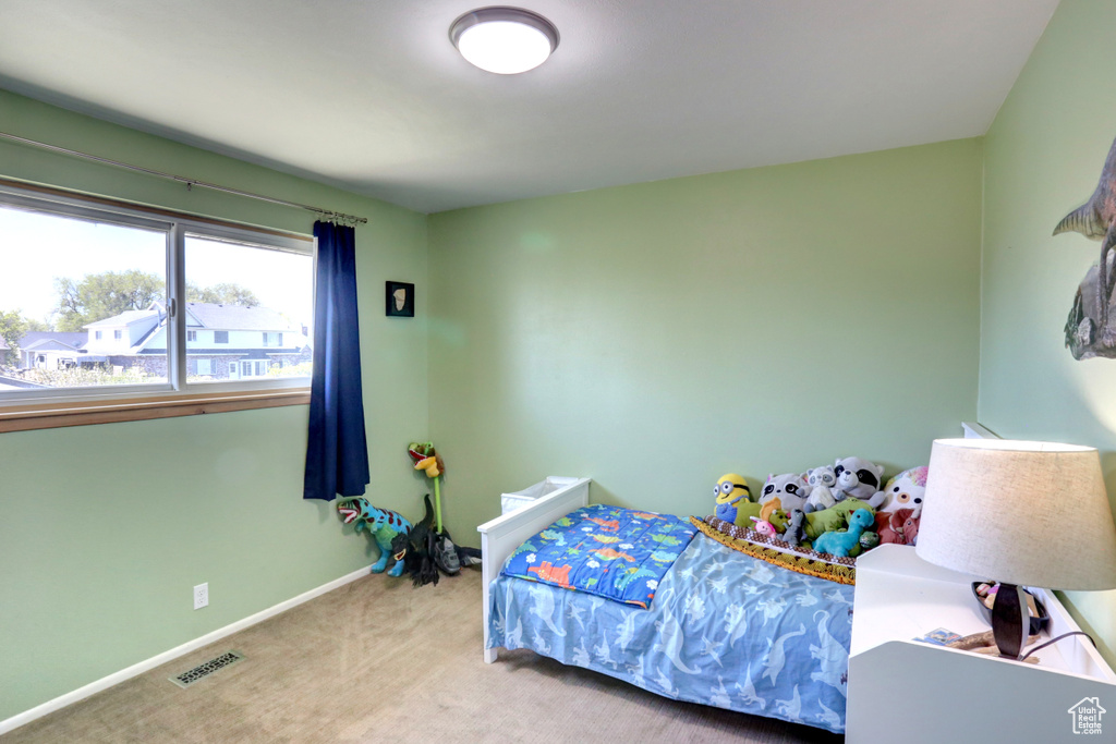 Bedroom featuring carpet floors, visible vents, and baseboards
