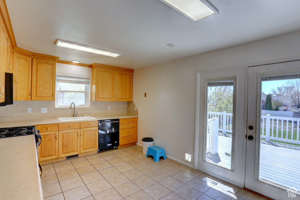 Kitchen with light countertops, a sink, visible vents, dishwasher, and light tile patterned floors