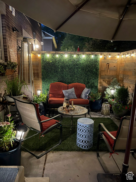 View of patio with an outdoor living space and fence