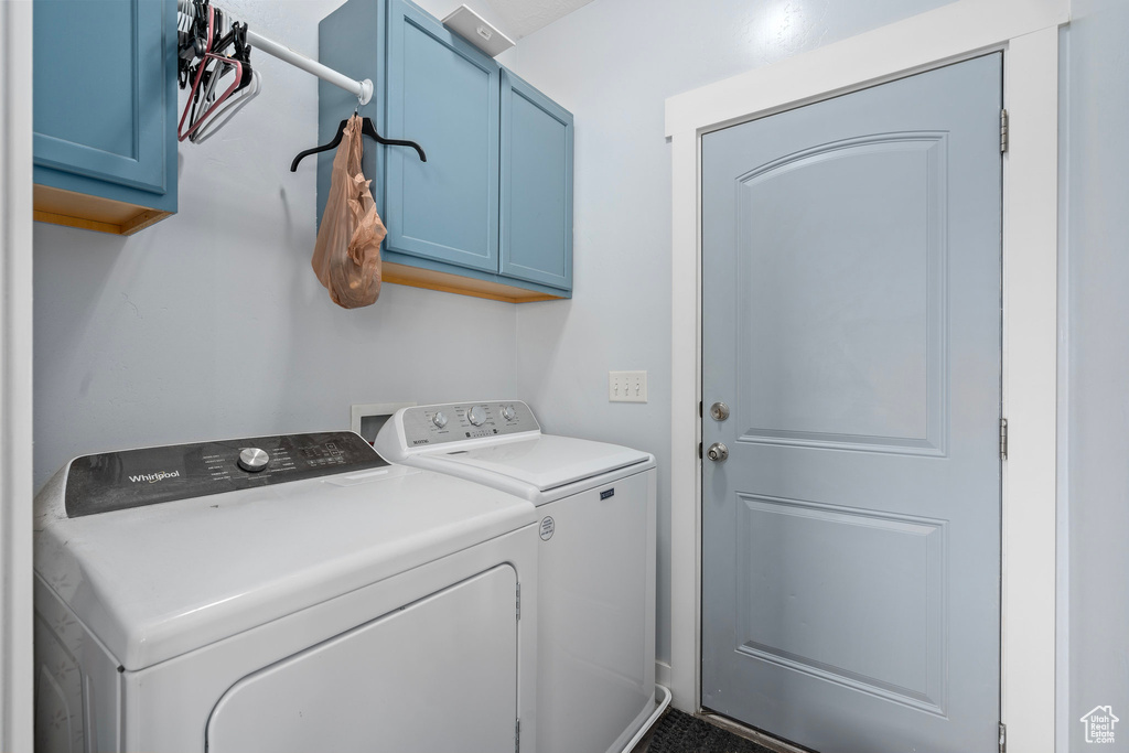 Laundry area with cabinet space and separate washer and dryer