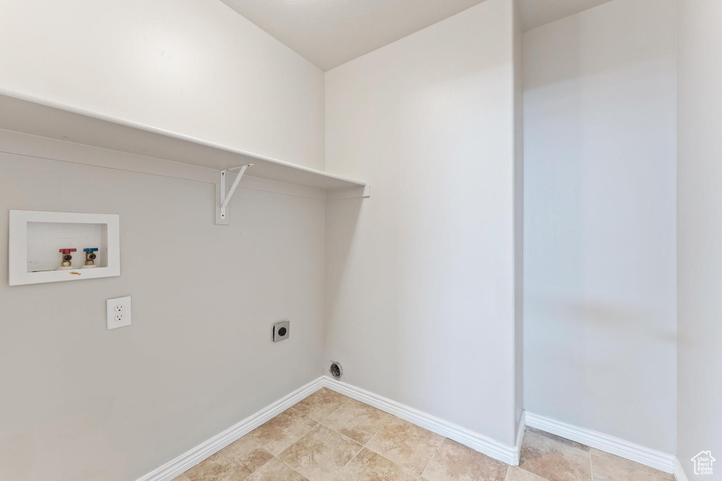 Laundry area featuring baseboards, electric dryer hookup, hookup for a washing machine, and laundry area