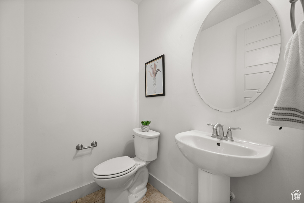 Bathroom featuring toilet and baseboards
