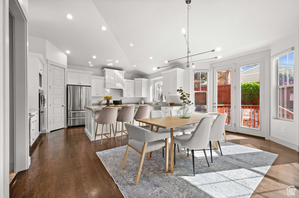 Dining room with recessed lighting, dark wood finished floors, and lofted ceiling