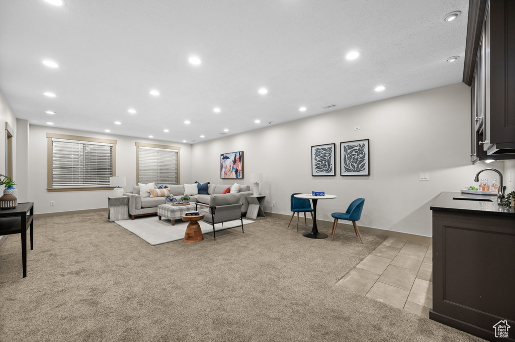 Living area featuring recessed lighting and light colored carpet