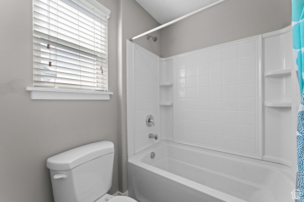 Full bath with shower / bath combination with curtain and toilet