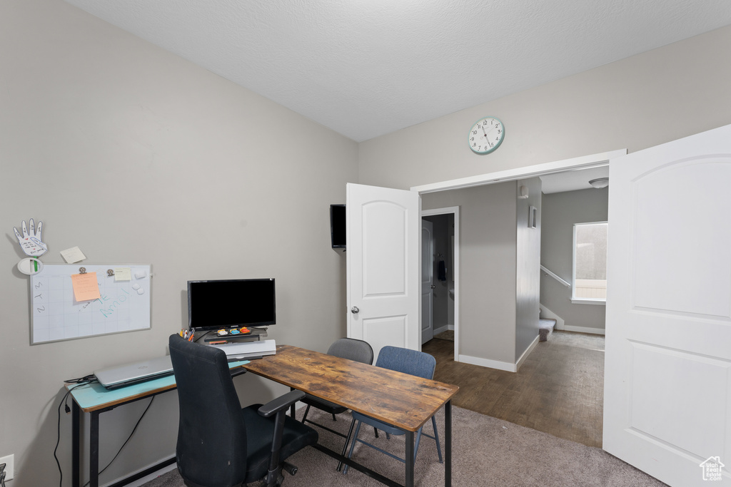 Home office featuring baseboards and wood finished floors