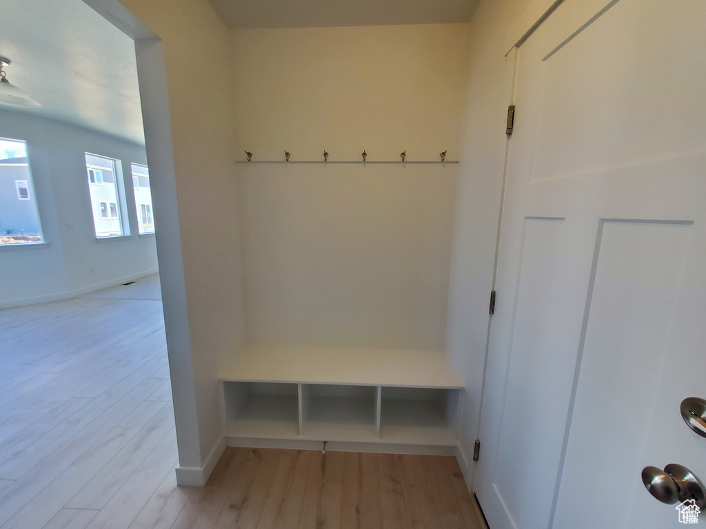 Mudroom with baseboards and light wood finished floors
