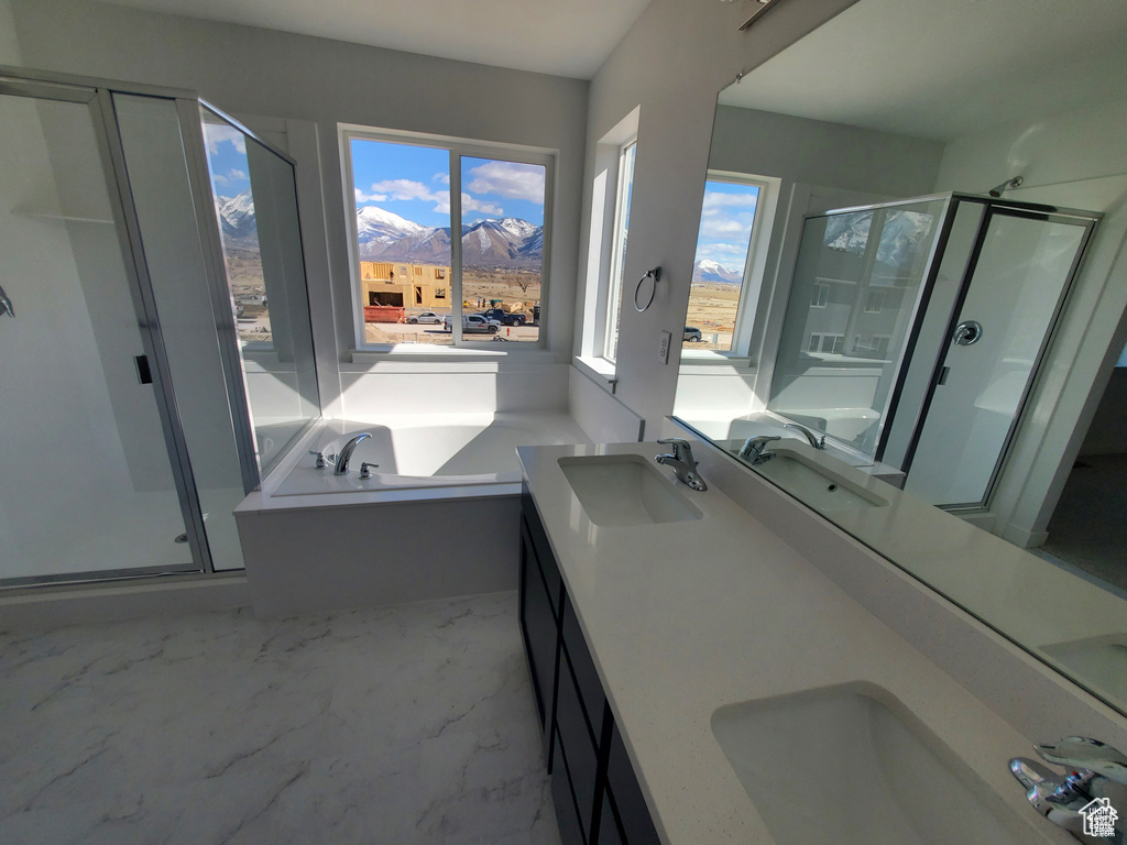 Bathroom with a sink, a shower stall, and marble finish floor