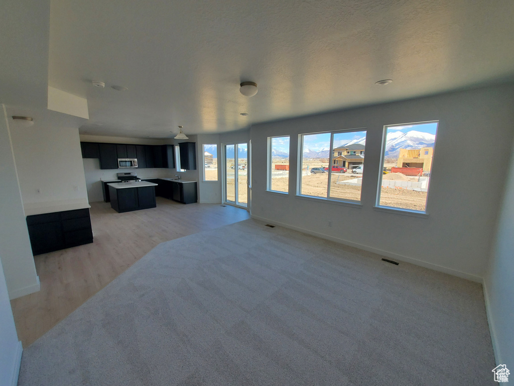 Living room featuring visible vents, baseboards, and light wood-type flooring