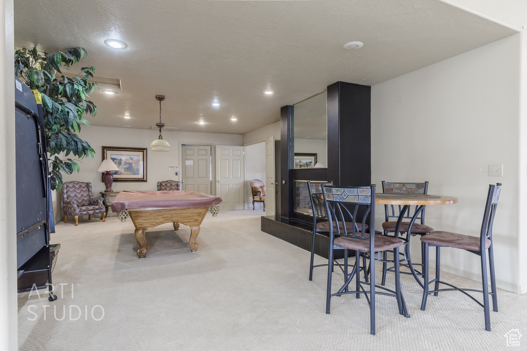 Recreation room with a textured ceiling, recessed lighting, light carpet, baseboards, and billiards