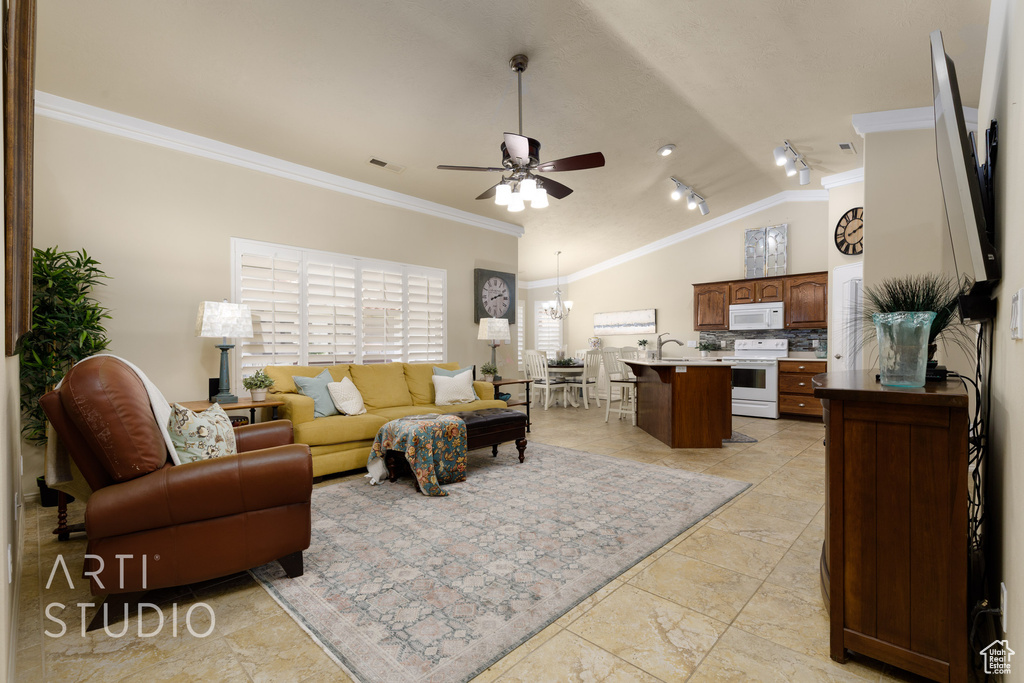 Living area with ornamental molding, ceiling fan, visible vents, and lofted ceiling