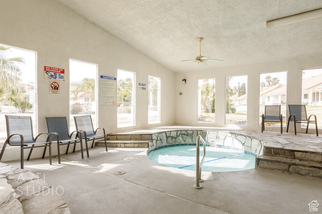 View of pool featuring a swimming pool, a ceiling fan, and an indoor in ground hot tub