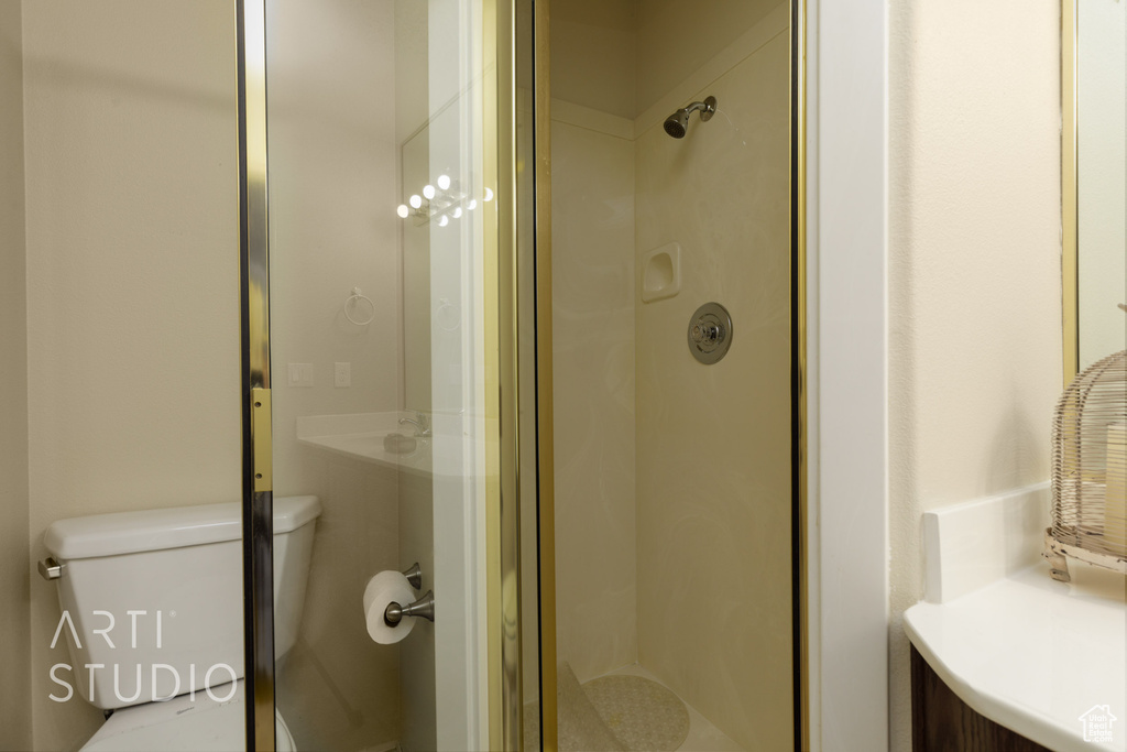 Bathroom featuring toilet and a stall shower