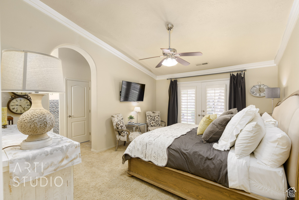 Bedroom featuring light carpet, visible vents, vaulted ceiling, and ornamental molding