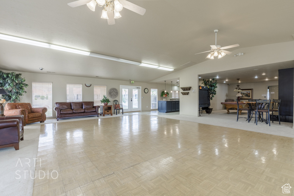 Miscellaneous room featuring a healthy amount of sunlight, high vaulted ceiling, and a ceiling fan